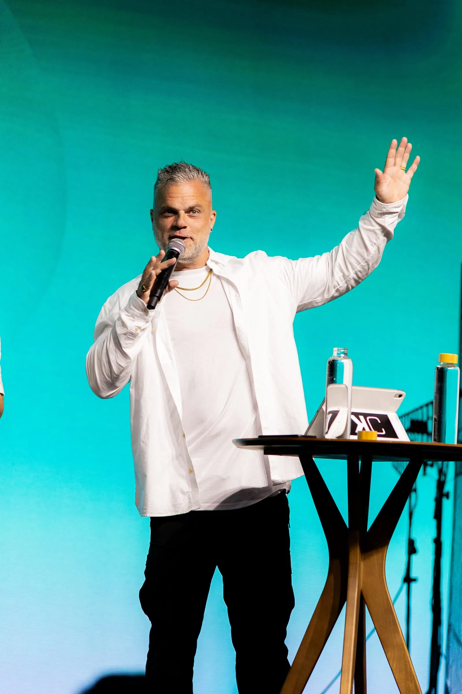 Shawn Gabie teaching on stage with arms open